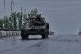 Ukrainian servicemen drive on an armored vehicle along a road covered with an anti-drone mesh corridor on May 17, 2026 in Druzhkivka, Donetsk region. Illustrative photo. (Source: Getty Images)