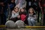People sit on a street near a destroyed building while waiting for news about the missing on May 14, 2026 in Kyiv, Ukraine. Illustrative photo. (Source: Getty Images)