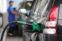 A fuel pump handle rests in the refilling nozzle of an automobile a gas station. Illustrative image. (Source: Getty Images)