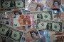 Photo illustration of the new £10 note is seen alongside euro notes and US dollar bills on October 13, 2017, in Bath, England.