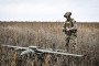 A soldier from a separate task force rifle battalion of the National Police of Ukraine in the Zaporizhzhia region holding a remote controller stands in the field near a GARA UAV in the Donetsk region, Ukraine on October 16, 2026. (Source: Getty Images)