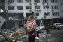 A woman holds her daughter outside a residential building damaged in a Russian ballistic missile strike on Kyiv, July 6, 2026. (Source: Getty Images)