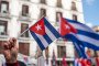 Illustrative image: a woman holds a Cuban flag during a protest. (Source: Getty Images)
