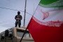 An armed Iranian police officer stands guard on an armored vehicle, monitoring the area during a state-run religious rally in downtown Tehran, Iran, on April 29. (Source: Getty Images)