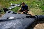 Dmytro Chubenko of the Kharkiv regional prosecutor’s office examines the carbon fiber remains of a Russian-made, Iran-designed Shahed-136 drone. (Source: Getty Images)