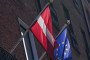The national flag of Latvia flies beside the European Union flag. (Source: Getty Images)