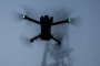 A DJI Mini 3 drone flies above the ground. (Source: Getty Images)