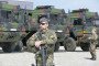 Soldiers stand on the grounds of the Breitenworbis highway maintenance depot in Thuringia, Germany, during a transnational Bundeswehr exercise. (Source: Getty Images)