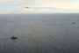 A Swedish fighter jet and naval vessel monitor a Russian submarine in the Kattegat Strait between Denmark and Sweden. (Source: Swedish Navy)