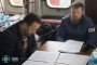 A Security Service of Ukraine (SBU) officer questions the detained foreign captain of a Russian shadow fleet vessel inside a ship’s cabin. (Source: Getty Images)