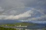 A rainbow spans over the US aircraft carrier USS Gerald R. Ford that is on its way into the Oslofjord, here at Drøbak and Oscarsborg, on September 12, 2025
