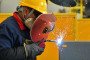 A worker on a production line assembling machine tool casings and auxiliary equipment in China. (Source: Getty Images)