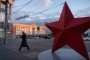 A woman walks past a red star installation, with the Kursk regional administration building. (Source: Getty Images)