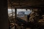 A man stands among the debris, looking out at the sea through a blown-out wall of an apartment destroyed by a Russian strike on September 17, 2026 in Odesa, Ukraine. (Source: Getty Images)