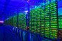 Illuminated mining rigs operate inside racks at the CryptoUniverse cryptocurrency mining farm in Nadvoitsy, Russia. (Source: Getty Images)