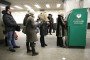 Customers line up to withdraw cash from an ATM operated by OAO Sberbank in Moscow, Russia, on March 22, 2013. (Source: Getty Images)