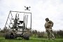 A soldier with the call sign ''Pavuk'' (''Spider'') watches a drone take off from a ground robotic complex during trials at a training ground on April 10, 2026. (Source: Getty Images)