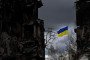 The Ukrainian flag flutters between buildings destroyed in bombardment, in the Ukrainian town of Borodianka, in the Kyiv region, on April 17, 2022.