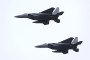 A pair of Japan Air Self-Defense Force F-15 fighter jets perform a flypast during a review parade as part of the National Defense Academy Entrance Ceremony in Yokosuka, Kanagawa Prefecture on April 5, 2026. (Source: Getty Images)
