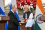 Vladimir Putin, Russia’s leader, left, shakes hands with Narendra Modi, India’s prime minister, during a news conference at Hyderabad House in New Delhi, India. (Source: Getty Images)