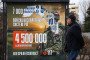 A man walks past an information billboard advertising contract service in the Russian Armed Forces, installed on one of the city streets. (Source: Getty Images)