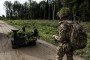 An operator of the Combat Gereon, an ARX Robotics GmbH uncrewed ground vehicle (UGV), during NATO-linked military exercises with British, Latvian, Canadian, and Italian forces, in Latvia, on October 5, 2025.