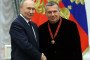 Russian leader Vladimir Putin (L) congratulates television propagandist Vladimir Solovyov (R) during an award ceremony at the Kremlin, on December 24, 2025, in Moscow, Russia.