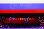 The Google logo is displayed on a mobile phone screen photographed with the Russian flag in the background, July 19, 2022. (Source: Getty Images)