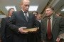 Russian leader Vladimir Putin holds a gold bar while visiting the Central Depository of the Bank of Russia on January 24, 2011, in Moscow.