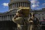 A Virginia National Guard soldier carries a crate of live ammunition on the east front of the U.S. Capitol on January 17, 2021, in Washington, DC. (Source: Getty Images)