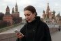 A woman attempts to access the internet using her smartphone while walking near the Kremlin on March 31, 2026, in Moscow, Russia. (Source: Getty Images)