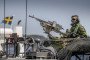A Swedish soldier sits on a military boat with a machine gun during the Baltic Operations NATO military drills (Baltops 22) on June 11, 2022, on Sweden's eastern coastline.