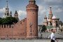 A pedestrian walks past the Kremlin and St. Basil’s Cathedral (R) in downtown Moscow on July 28, 2026. (Source: Getty Images)