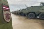 Latvian soldiers stand during the handover of 21 Patria 6x6 armored transport vehicles to the Ukrainian armed forces at the Latvian military base. (Source: Getty Images)