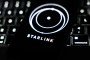 A laptop keyboard and Starlink logo displayed on a phone screen are seen in this illustration photo taken in Krakow, Poland on March 11, 2025. (Source: Getty Images)