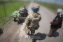 Ukrainian paratroopers help an elderly civilian flee the frontline village.