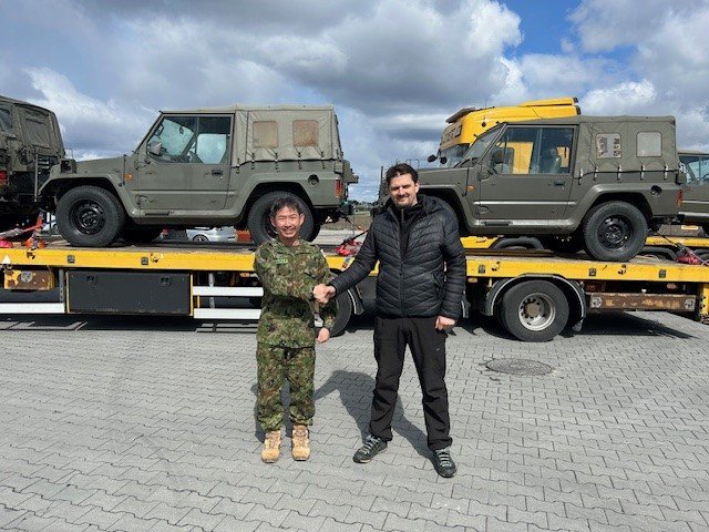 A representative of Japan’s Self-Defense Forces and a Ukrainian official shake hands in front of military vehicles being transferred to Ukraine. (Source: Embassy of Japan in Ukraine) A representative of Japan’s Self-Defense Forces and a Ukrainian official shake hands in front of military vehicles being transferred to Ukraine. (Source: Embassy of Japan in Ukraine)